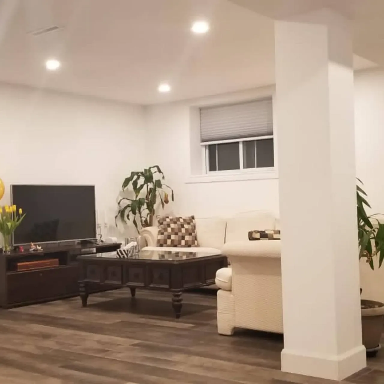 Finished basement family room with pot lights and vinyl plank flooring