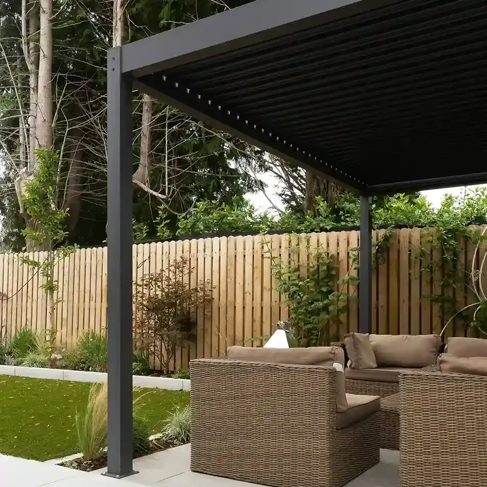 Louvered aluminum pergola over a backyard patio seating area
