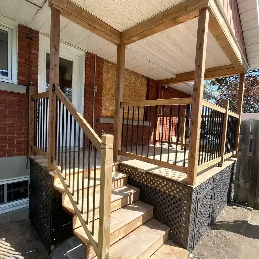 Rebuilt front porch with new wood posts, railing, and stairs on a brick home
